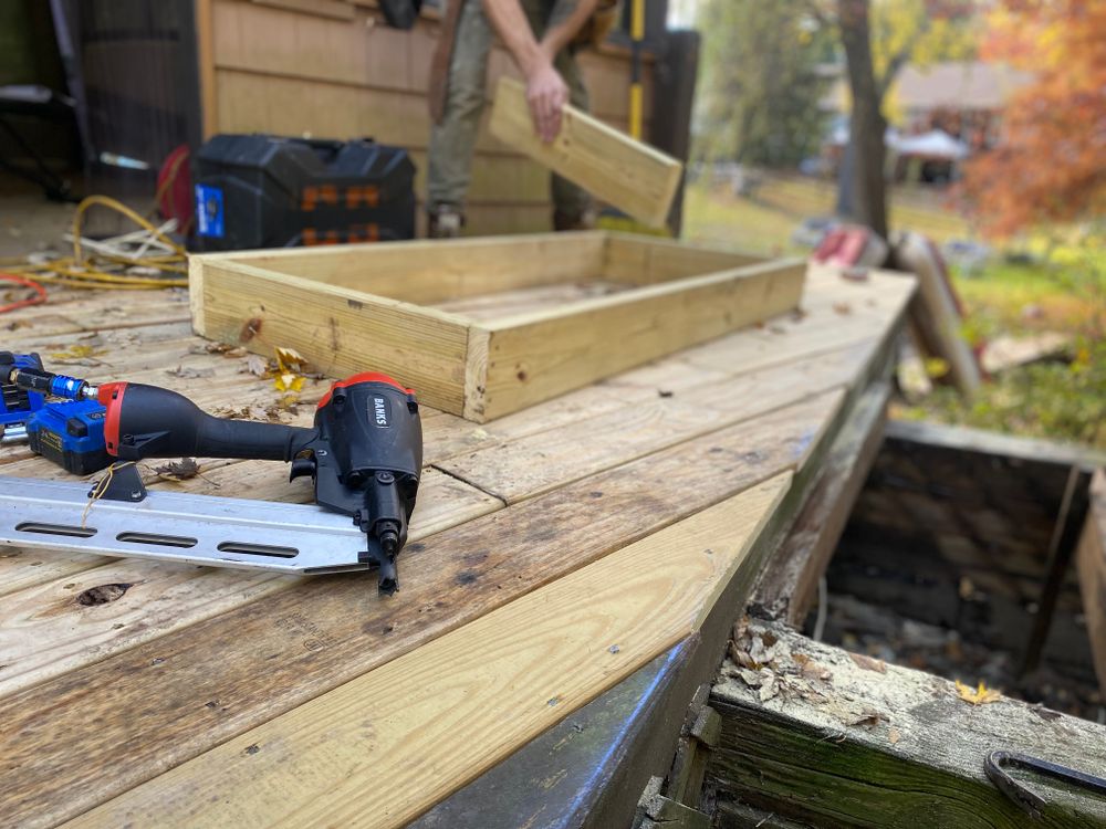 Deck boards being fastened with a nail gun during construction